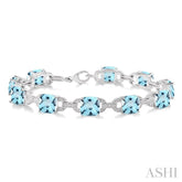 7x7 MM Cushion Shape Blue Topaz and 1/20 ctw Round Cut Diamond Fashion Bracelet in Sterling Silver